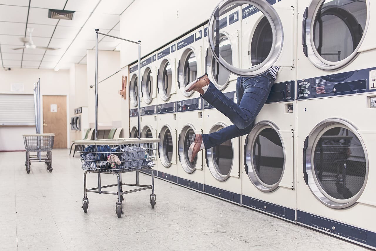 Rows of coin-operated washers and dryers at a laundromat